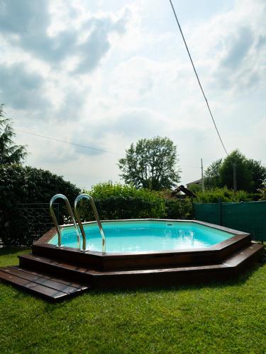 a swimming pool in the grass with two handles at Casa Fornace 28 in La Morra