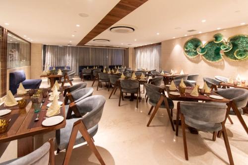 a dining room with wooden tables and chairs at Best Western La Vista Pathankot in Pathānkot