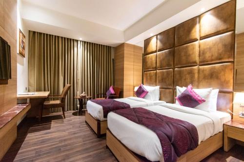 Ένα ή περισσότερα κρεβάτια σε δωμάτιο στο Best Western La Vista Pathankot