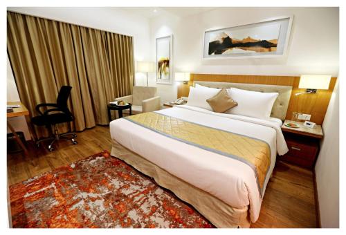 a bedroom with a large bed in a hotel room at Best Western Plus Tejvivaan in Visakhapatnam
