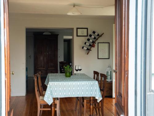 a dining room table with chairs and a table cloth at Casa Fornace 28 in La Morra