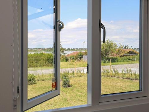 an open window with a view of a field at 6 person holiday home in Karrebæksminde-By Traum in Karrebæksminde