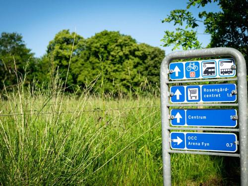 a sign in front of a field of grass at Best Western Plus Hotel Odense in Odense
