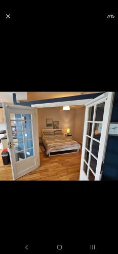 a bedroom with a bed and open doors at Wexford Quayfront Apartments 1, 2, 3 & 4 in Wexford