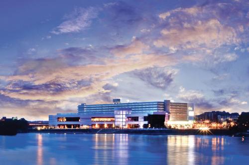 a large building next to a body of water at Holiday Inn Weirton-Steubenville Area in Weirton