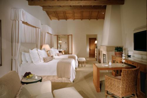 a bedroom with a bed and a living room at The Resort at Pelican Hill in Crystal Cove