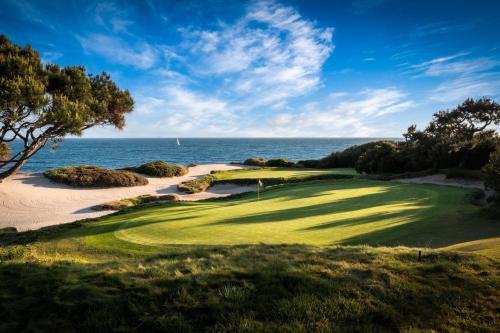 a golf course with the ocean in the background at The Resort at Pelican Hill in Crystal Cove