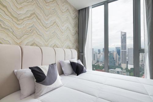a white couch in a room with a window at The Echelon Sukhumvit 11 by LeFoyer in Bangkok