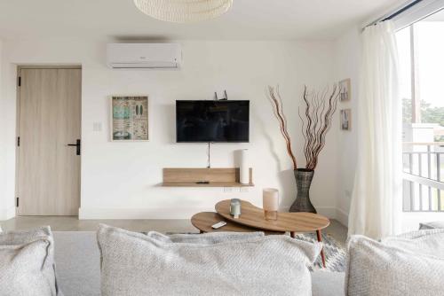 a living room with a couch and a table at Charming & Spacious 2BR Condo E22 at Playa Venao in Playa Venao