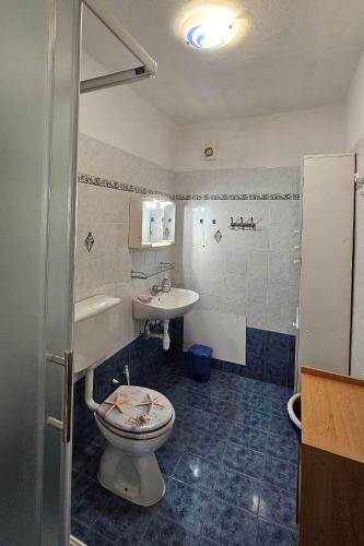 a bathroom with a toilet and a sink at Apartments with parking space Pinezici, Krk - 5319 in Pinezici