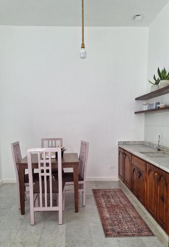 a dining room with a table and chairs and a kitchen at The Ranch in Kfar Hazîr