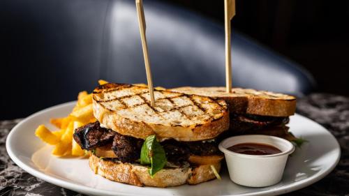 a sandwich and french fries on a white plate at Holiday Inn Sydney Potts Point in Sydney