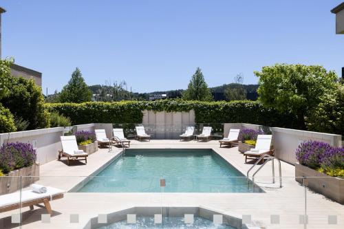 a swimming pool with lounge chairs and a patio at Holiday Inn Express - Temuco by IHG in Temuco
