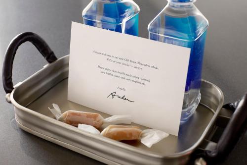 two bottles of water in a tray with a note at Archer Hotel Old Town Alexandria in Alexandria