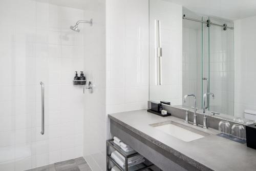 a bathroom with a sink and a shower at Archer Hotel Old Town Alexandria in Alexandria
