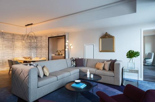 a living room with a couch and a table at Archer Hotel Old Town Alexandria in Alexandria