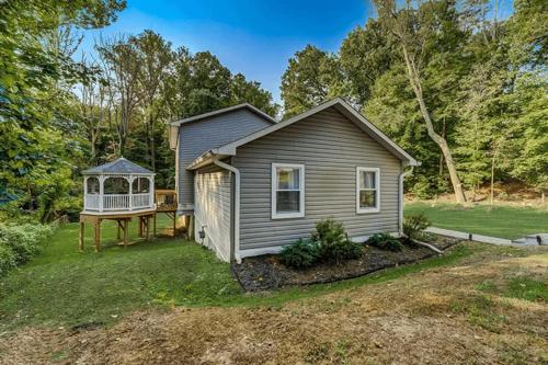 a small house with a gazebo in the yard at Stylish and Modern Large Bedroom in Parkland Terrace
