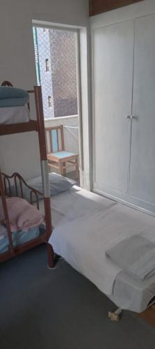 a bedroom with two bunk beds and a large window at Luz de Regina Hospedagem in Salvador