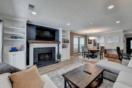 a living room with a couch and a fireplace at Walk to Avalon or Downtown 3 in Alpharetta