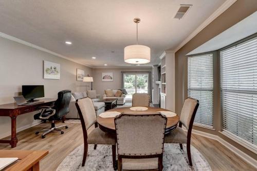 a dining room with a table and a living room at Walk to Avalon or Downtown 3 in Alpharetta