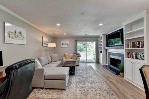 a living room with a couch and a fireplace at Walk to Avalon or Downtown 3 in Alpharetta