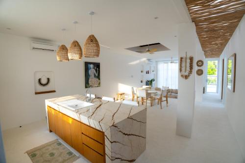 a kitchen and dining room with a stone counter top at Sonnys Uluwatu in Uluwatu