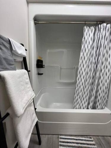 a bath tub with a shower curtain in a bathroom at Crystal's Place in Moncton