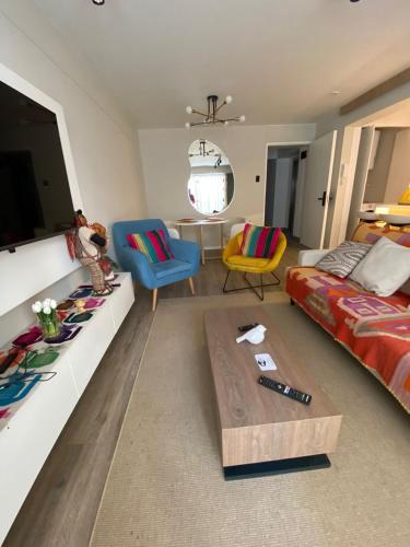 a living room with a couch and a table at DEPARTAMENTO KILLA HUATANA in Cusco