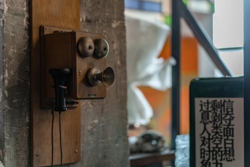 a wooden door with knobs on a wall at Zhangjiajie Wangyi Inn in Zhangjiajie