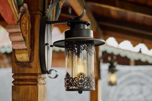 a black lantern hanging on a wall at Uddhara Ubud Villa in Ubud