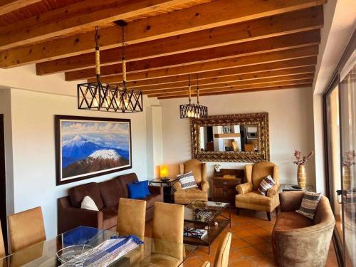 a living room with a couch and a table at Lovely 3BD 4BA APT Pool Gym Parking in San Miguel de Allende