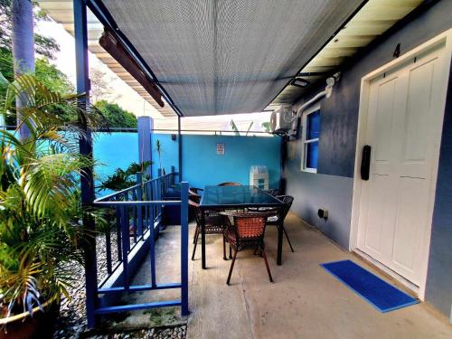 a patio with a table and chairs on a balcony at Hidden Palms Inn & Resort Quadruple in San Juan