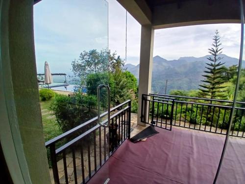 a balcony with a view of the mountains at Awesome Place in Ella