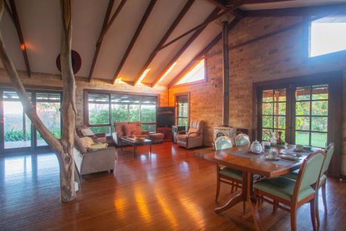 a large living room with a table and chairs at Stone Cottage in Possum Brush
