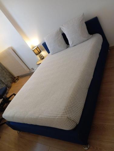 a large bed with white sheets and pillows at Noxio voyages in Evry-Courcouronnes
