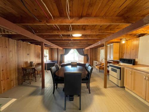 a kitchen and dining room with a table and chairs at Muskoka Sandy Beach Cottage in Bala