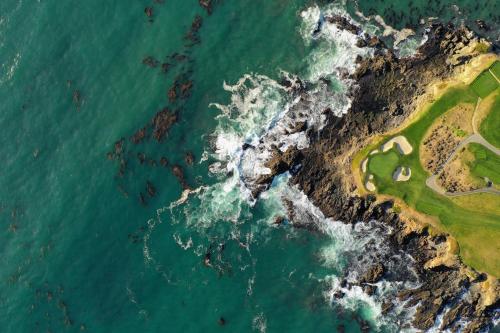an aerial view of a golf course next to the ocean at Holiday Inn Express at Monterey Bay by IHG in Seaside
