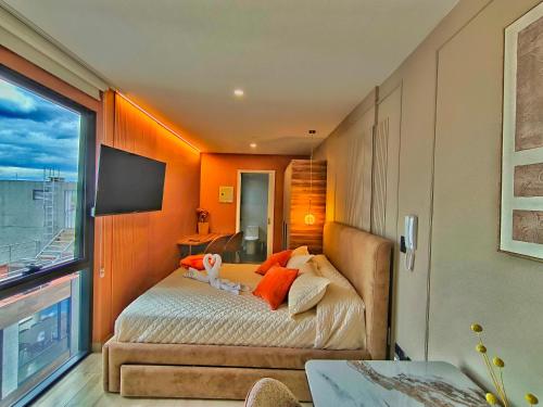 a bedroom with a large bed with orange walls at Republica del Salvador Coliving Ecuador XOE in Quito
