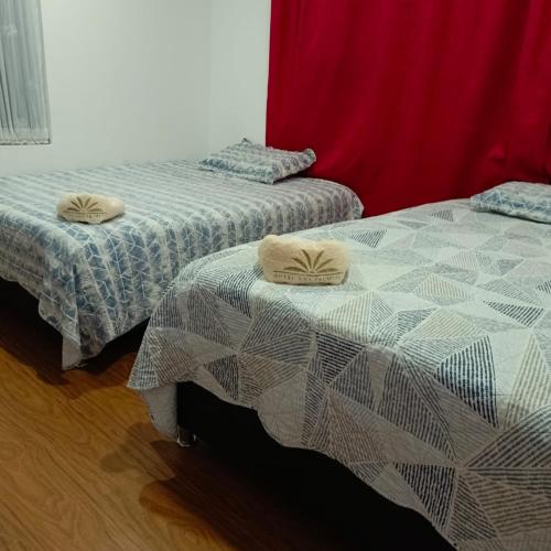 two beds sitting next to each other in a room at Centro Recreativo Las Palmeras in Gachancipá