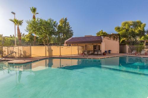 a large swimming pool in front of a house at Lakeside Lake Biltmore Village Condo in Phoenix