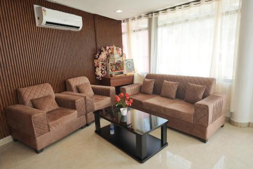 a living room with two couches and a coffee table at The Retreat in Mirzāpur