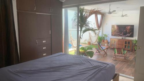 a bedroom with a bed and a room with a plant at Casa Intensamente in Jesús María
