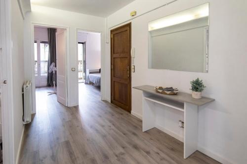 a living room with a large mirror on the wall at Sant Ferriol in Olot