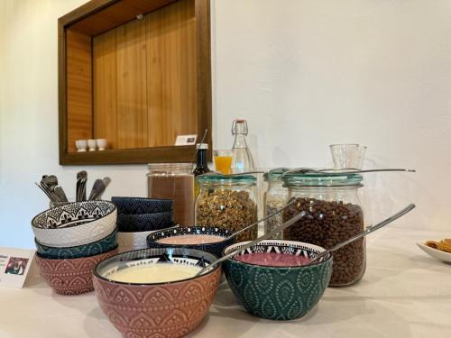 a counter with four bowls of food on a table at Landhaus Königsreiner in Kolbnitz