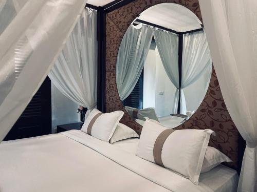 a bedroom with a large bed with a mirror at A'Famosa Resort Melaka in Melaka