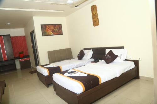 a bedroom with two beds in a room at Park Niveda in Shamshabad