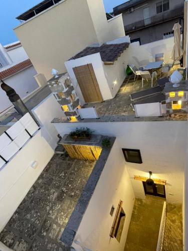 an overhead view of a white building with a patio at Casina Li Fumareddhi in Corsano