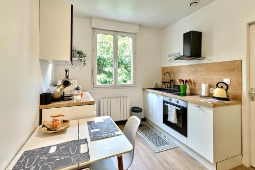 une cuisine avec une table et un comptoir dans l'établissement Agréable studio en hyper centre, à Nevers