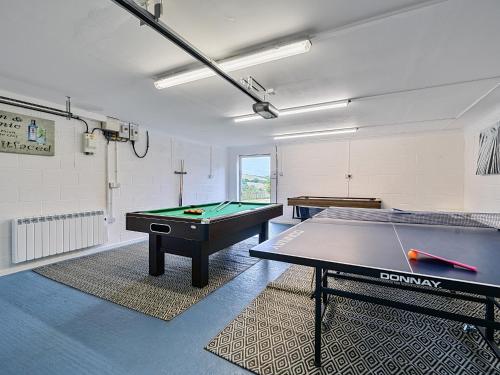 a room with a ping pong table in it at Mallacleave House in Bideford