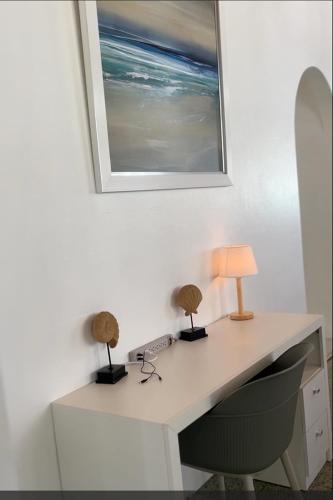 a desk with two lamps and a picture on the wall at The ARC in Scarborough